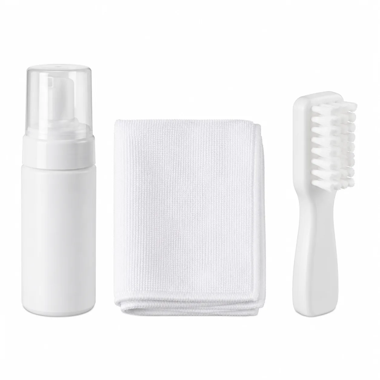 Foam cleaner bottle, microfibre cloth and midsole brush in a row