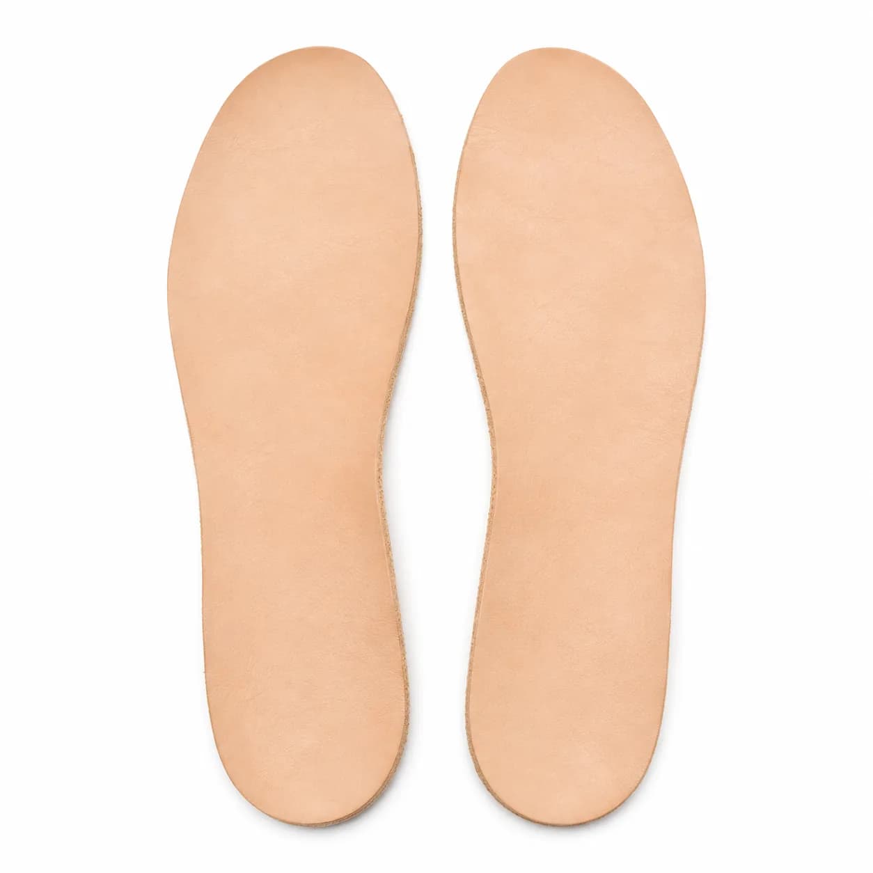 A pair of natural leather insoles lying flat side by side